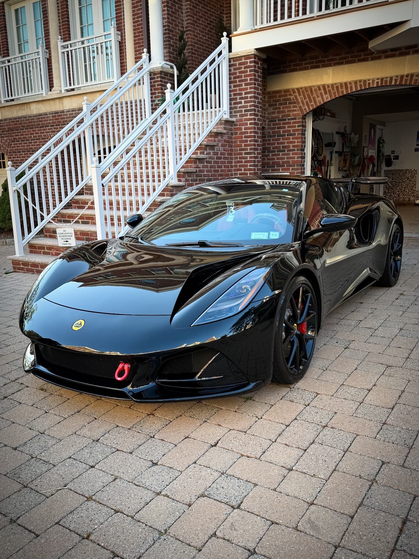 Black Lotus Emira freshly detailed in a client's driveway