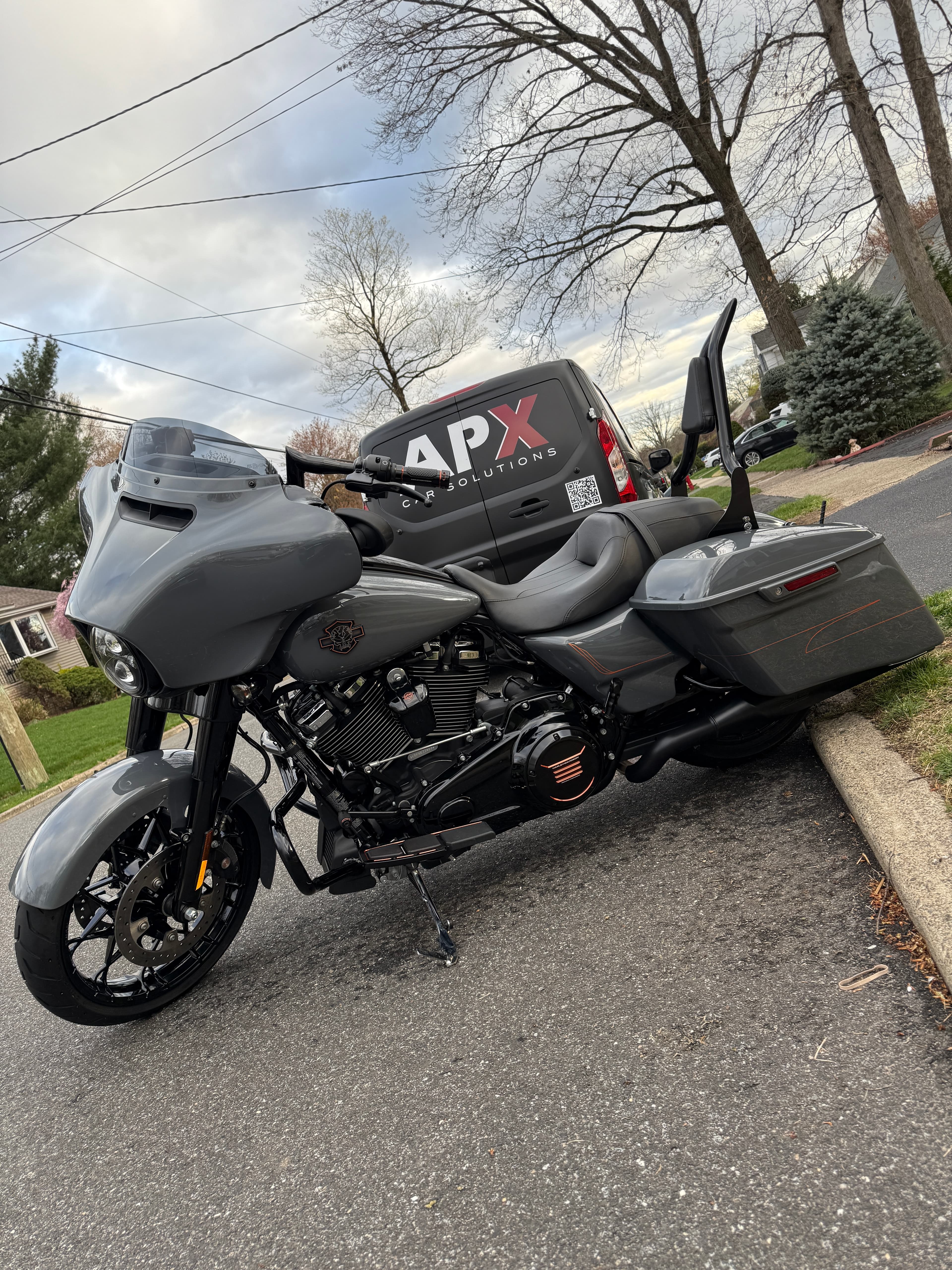 Gray Harley-Davidson Street Glide freshly detailed with the APX van behind it