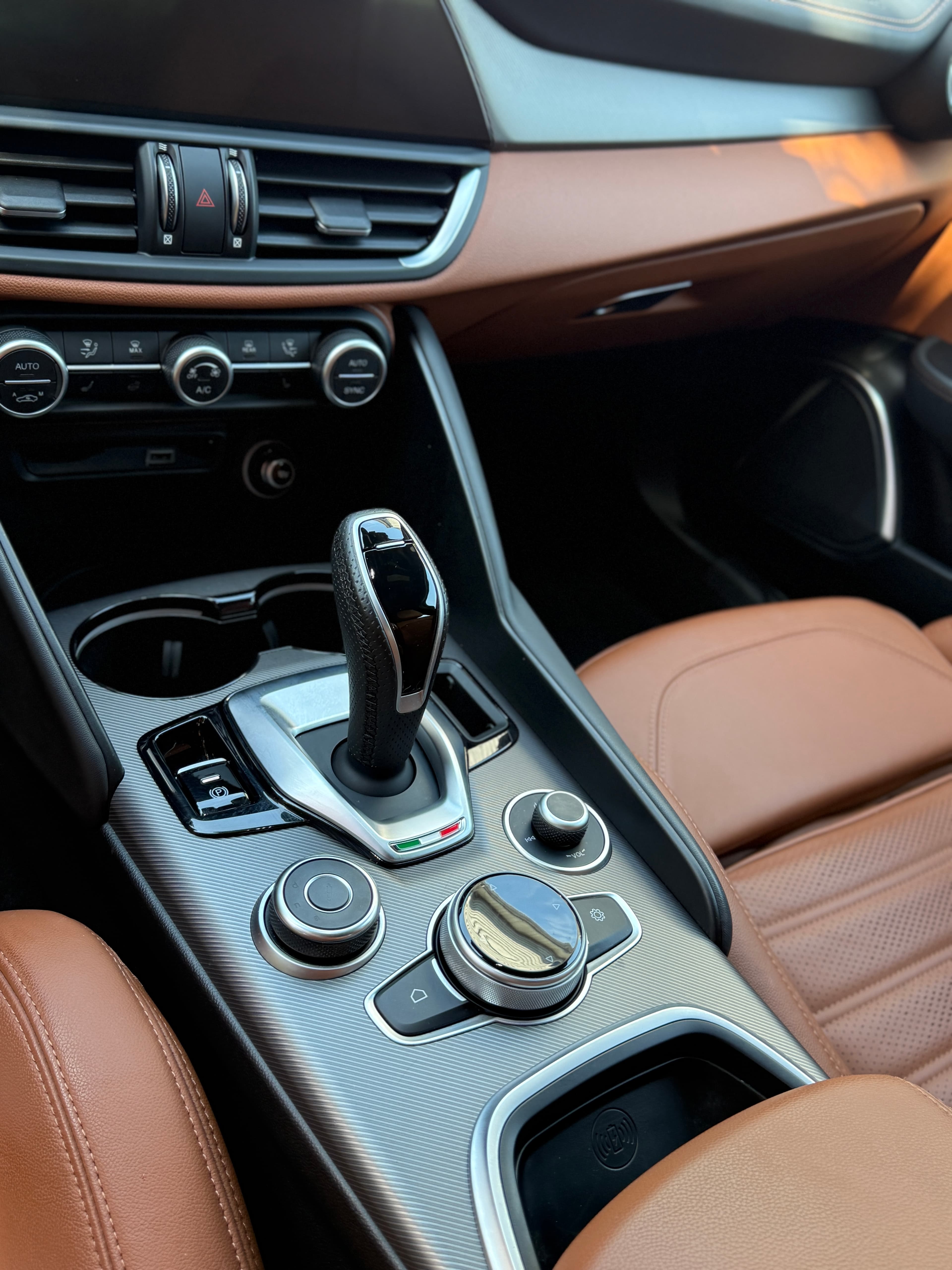 Deep-cleaned brown leather interior of an Alfa Romeo Giulia after a full detail