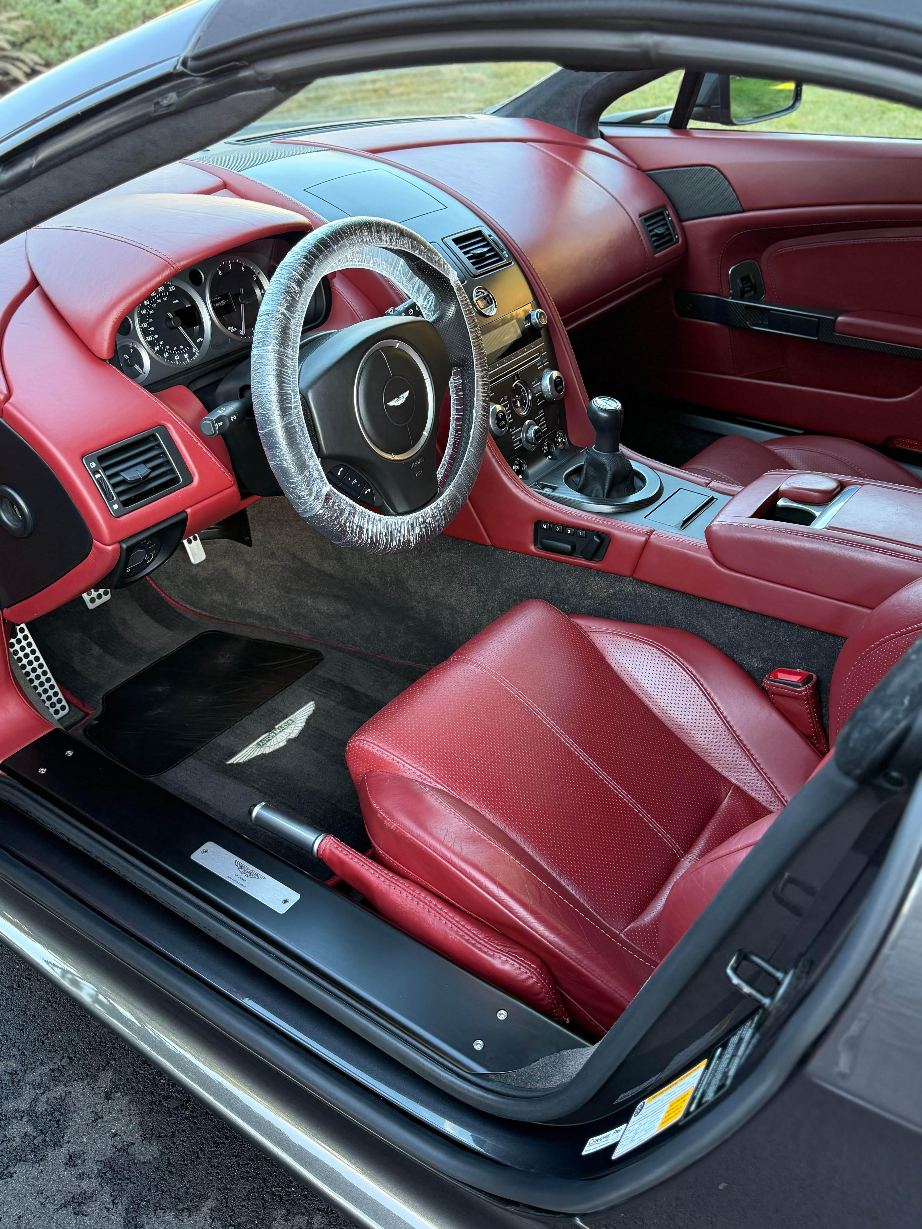 Deep-cleaned red leather interior of an Aston Martin V8 Vantage after a full detail