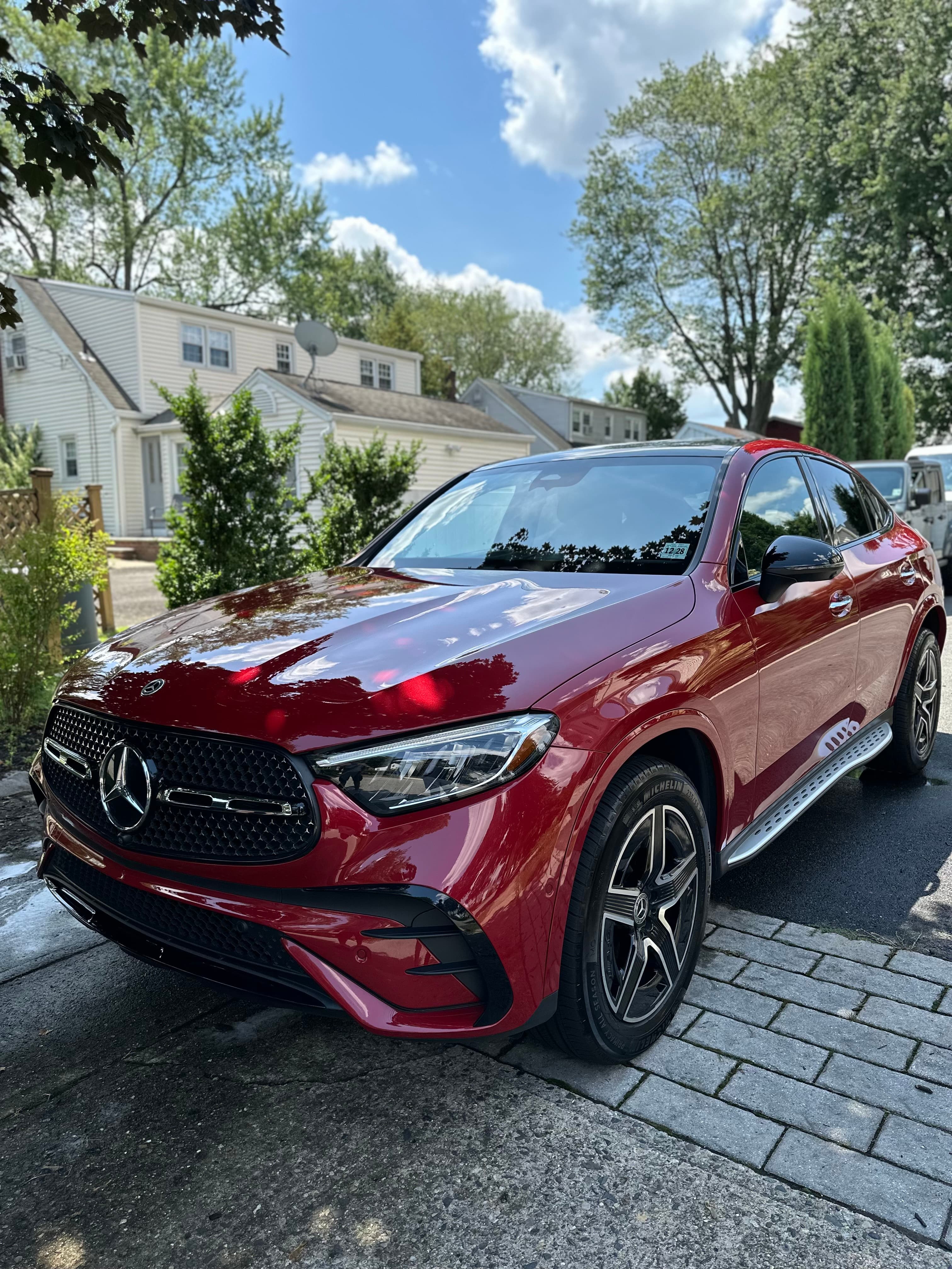 Red Mercedes-Benz GLC coupe shining after a detail on a Harrington Park street