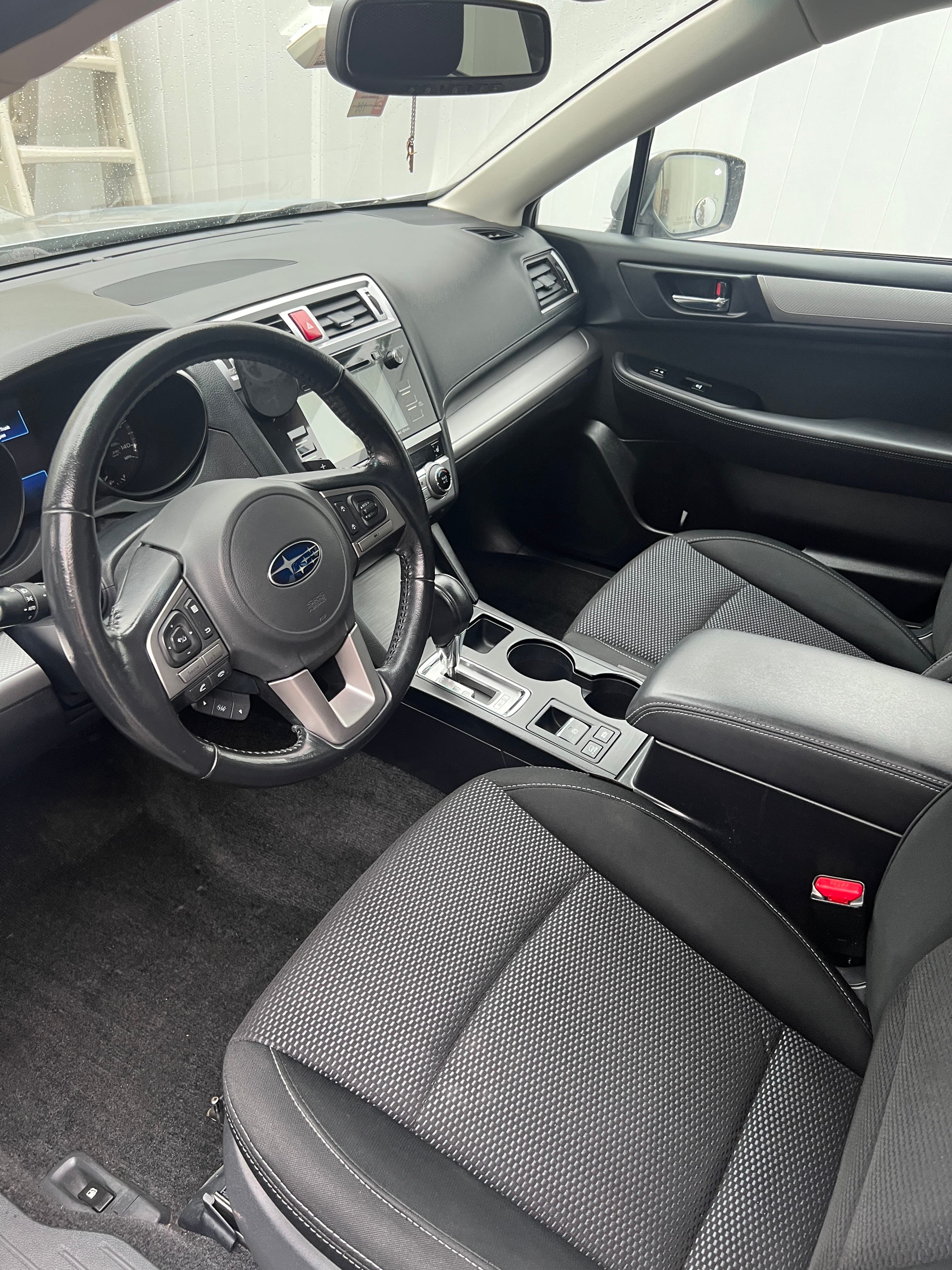 Freshly deep-cleaned Subaru Legacy interior in a Hillsdale driveway